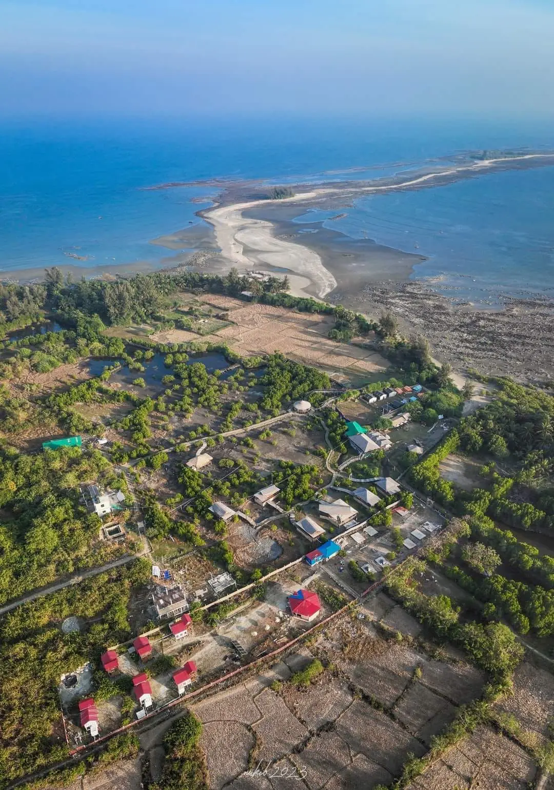Aerial view over the island's villages, trees and coastline