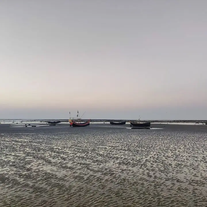 Fishing boats at low tide on a calm beach