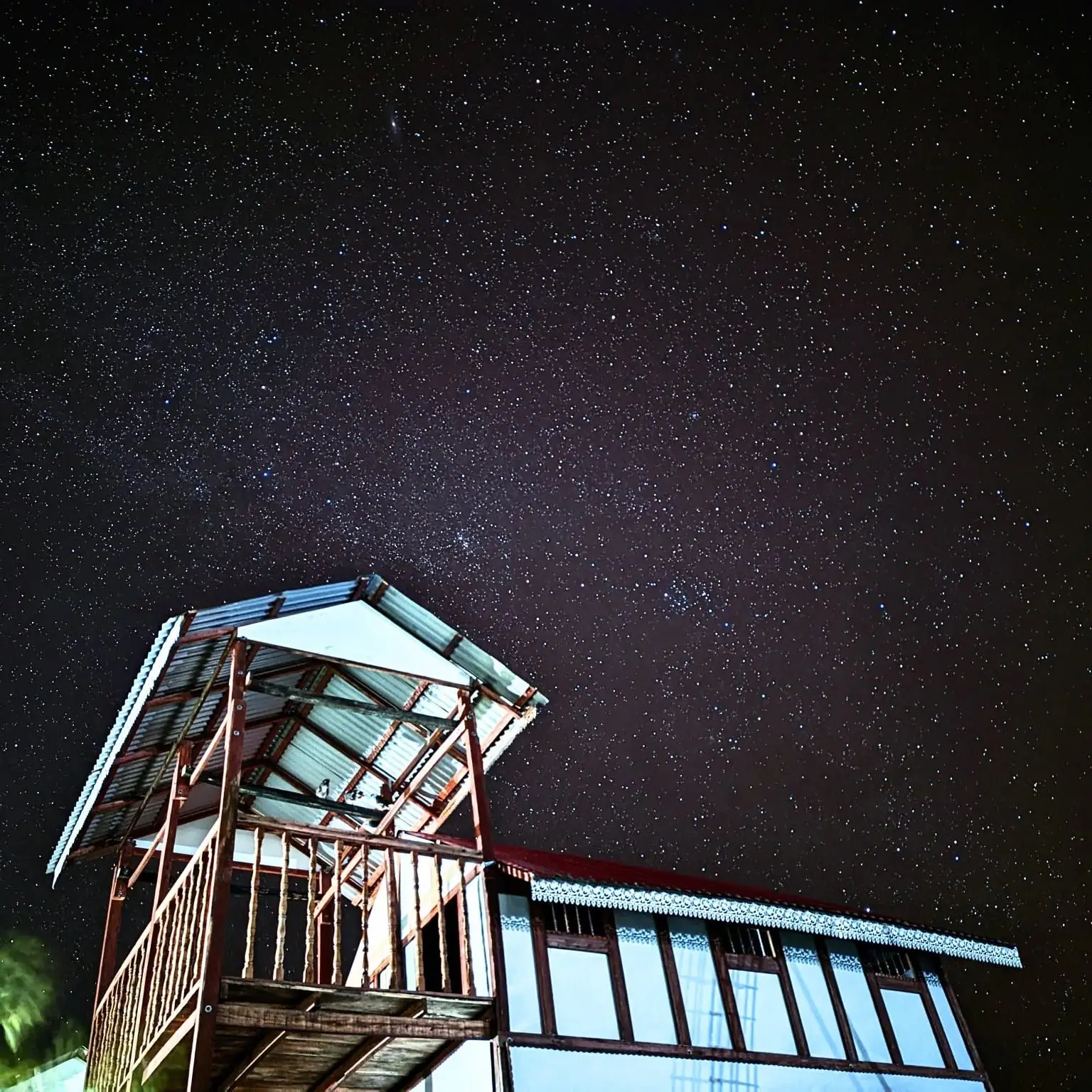 Cottage lookout under a starry night sky