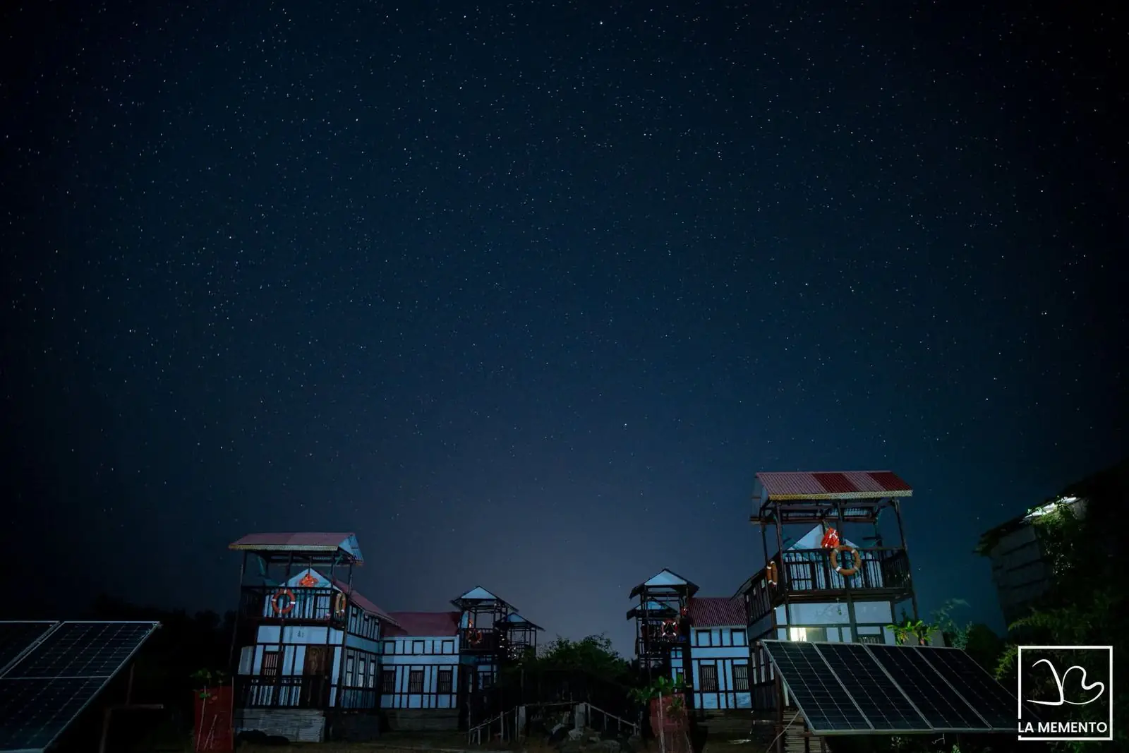 The duplex cottages and their lookout towers under a starry night sky
