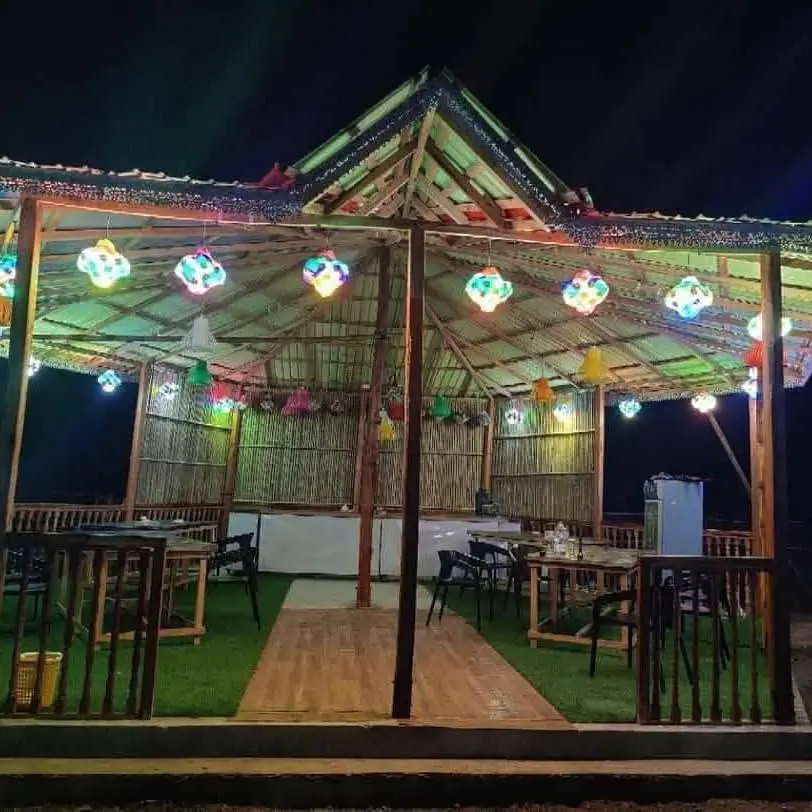 Our open-air restaurant lit with colourful lanterns at night