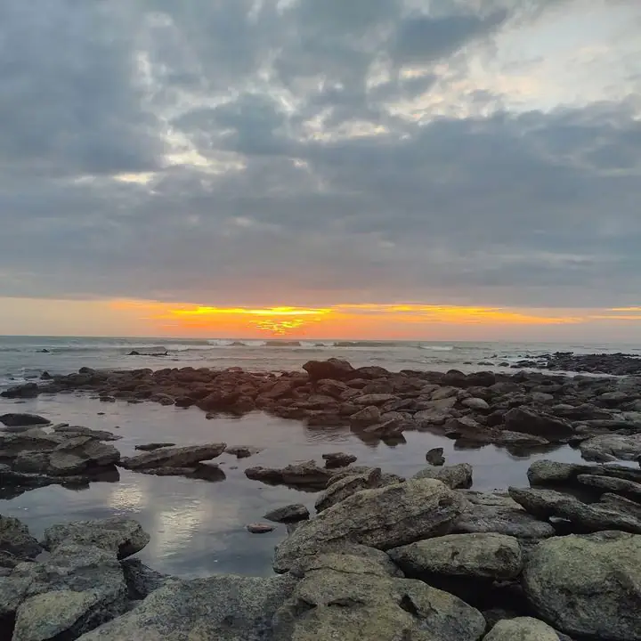 Sunset over the rocky shore and tide pools